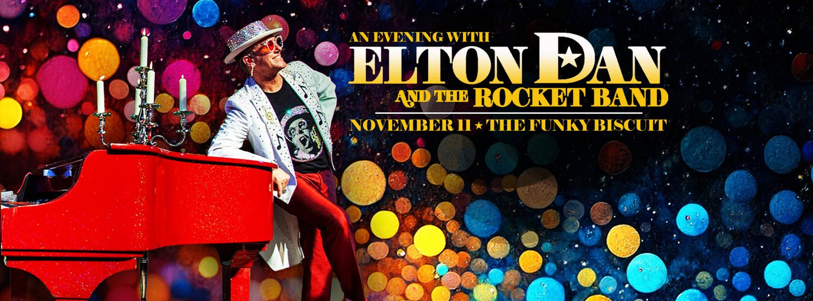 A shot of Elton Dan and the Rocket band on stage with the crowd in the foreground. White lights are shining beams of light in all directions from the stage.